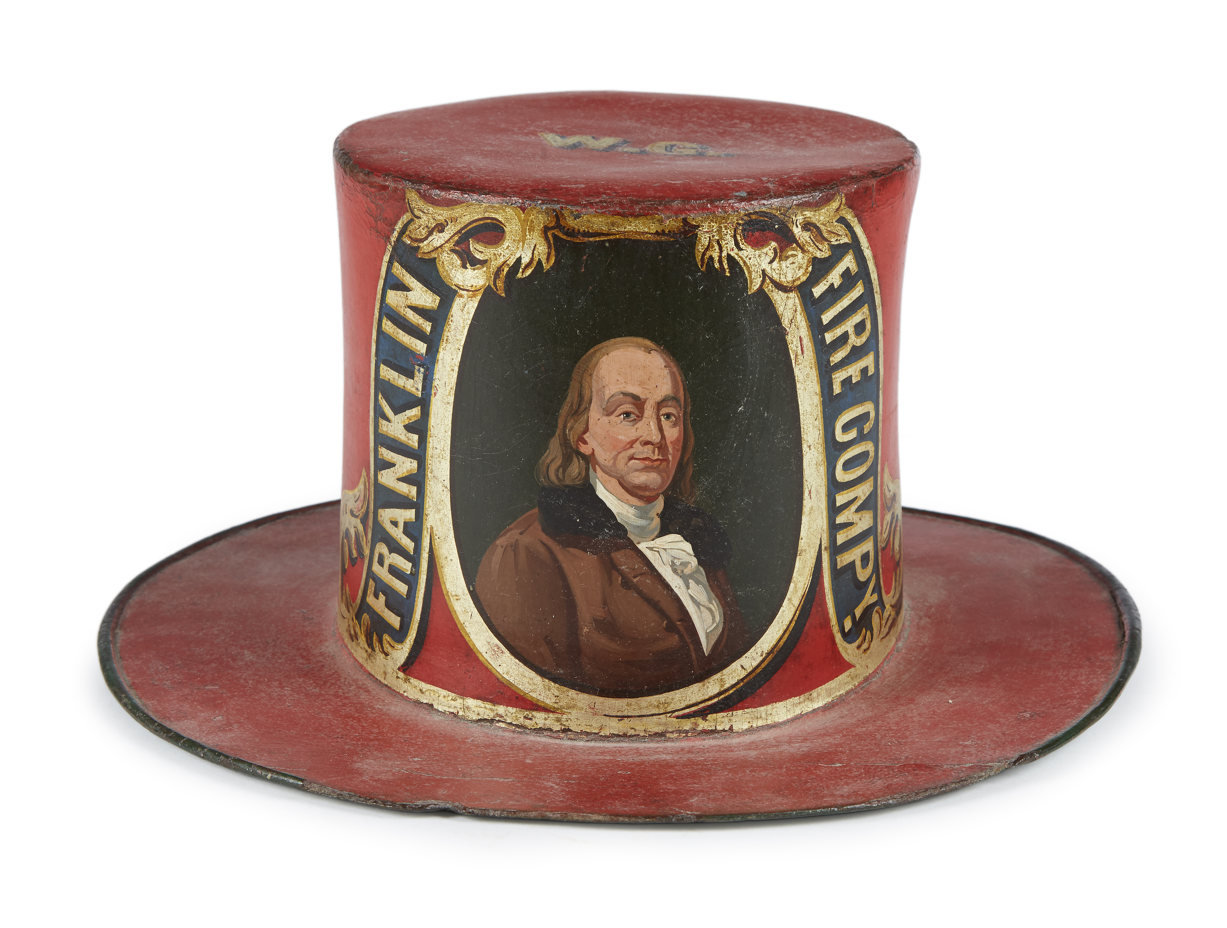 A painted and decorated leather and felt parade hat for the Franklin Fire Company, a volunteer fire-fighting company which was active in Germantown, Philadelphia, Pennsylvania. It dates to between 1840 and 1860, stands six and a half inches tall, and measures a bit over 13 inches in diameter.