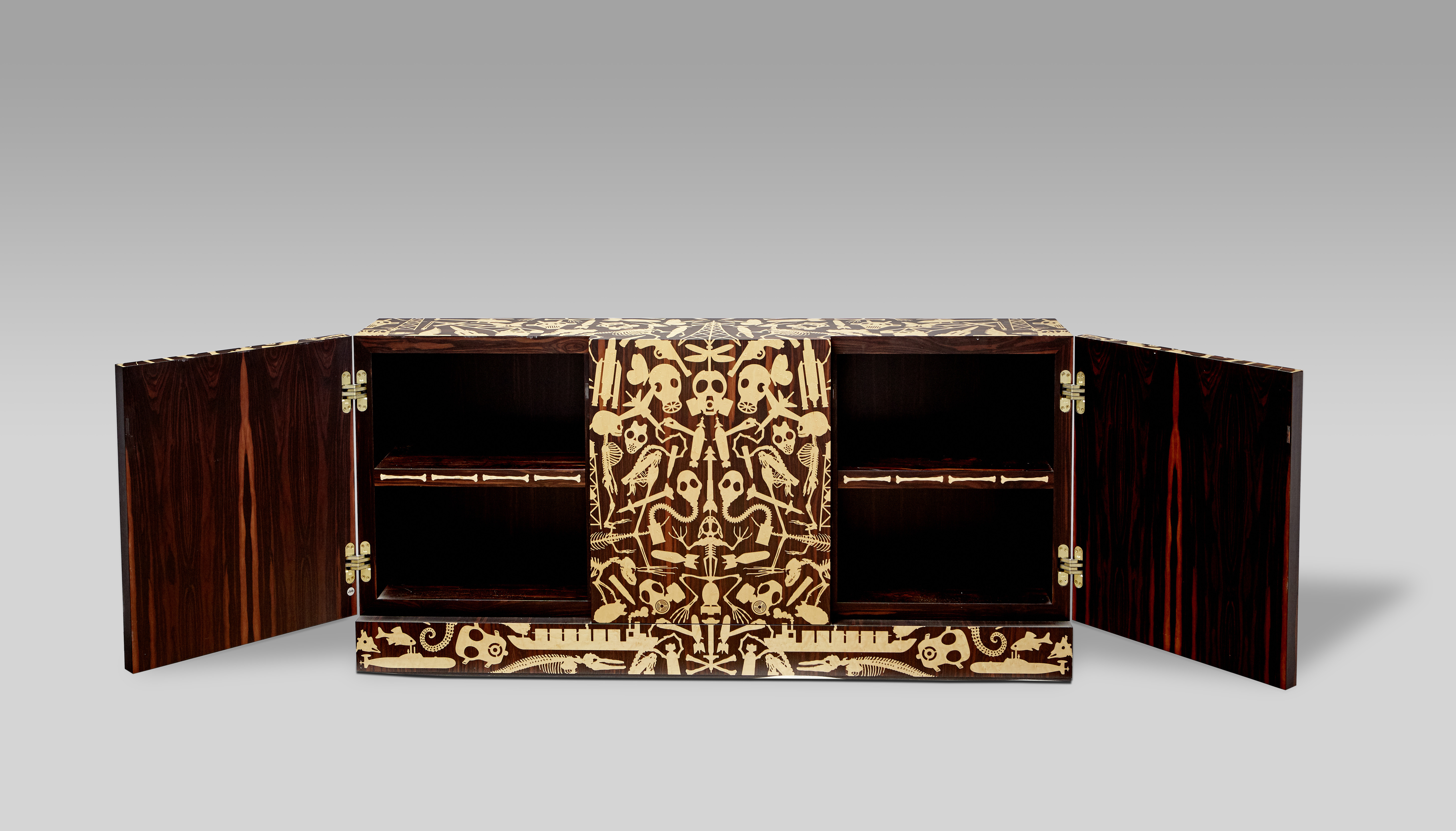 A full shot of the unique "dressoir" made by Studio Job, with the doors open to reveal details of bird's eye maple bone images inlaid on the edges of the shelves.