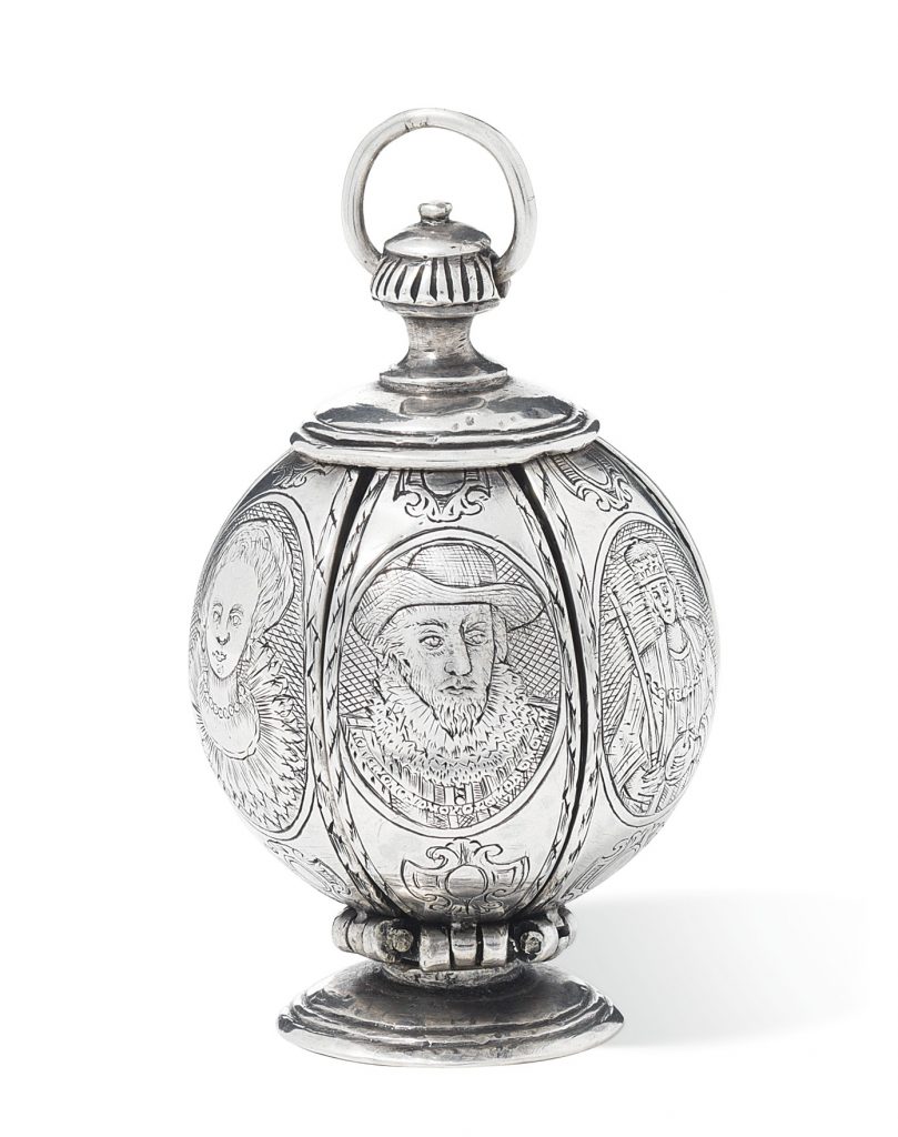 This side of the silver pomander shows a man wearing a ruff and hat. It's believed to be a portrait of King James I. The man on the right with orb and scepter could be King Henry VIII, and the woman on the right is now believed to be Anne of Denmark, James's wife, or possibly a queen of Bohemia. 