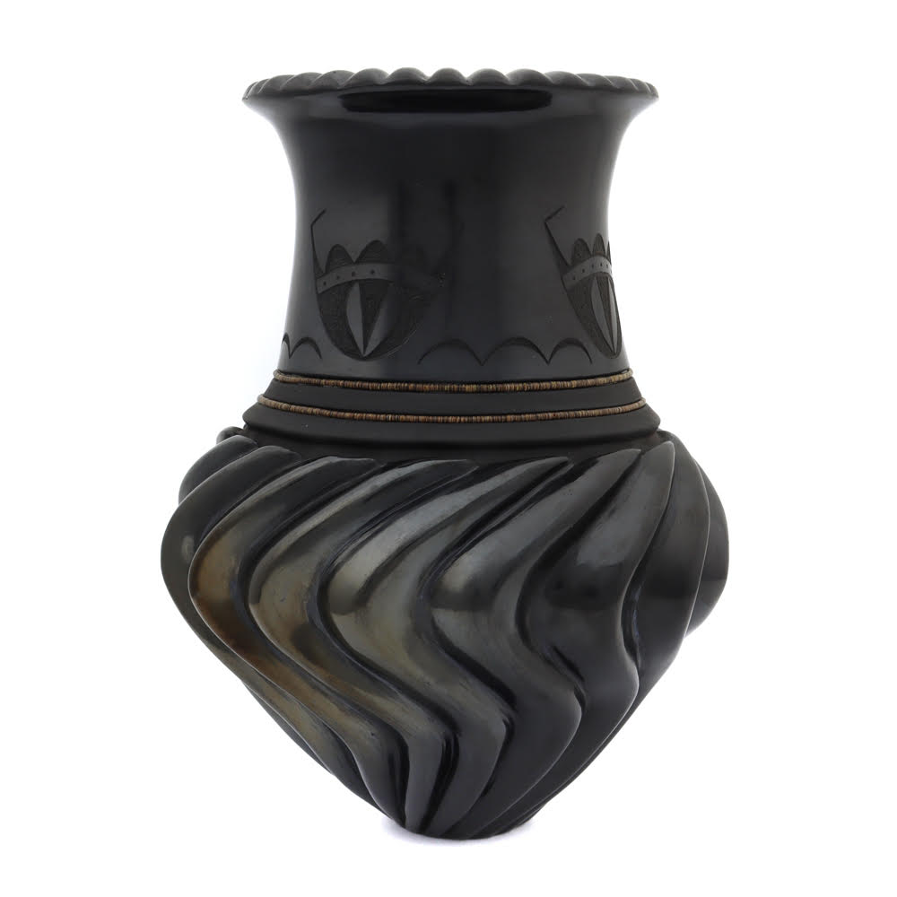 Nancy Youngblood contributed the scalloping at the mouth of the vase and the ribs on the lower half. Russell Sanchez decorated the neck with sgraffito etchings and heishi beads.