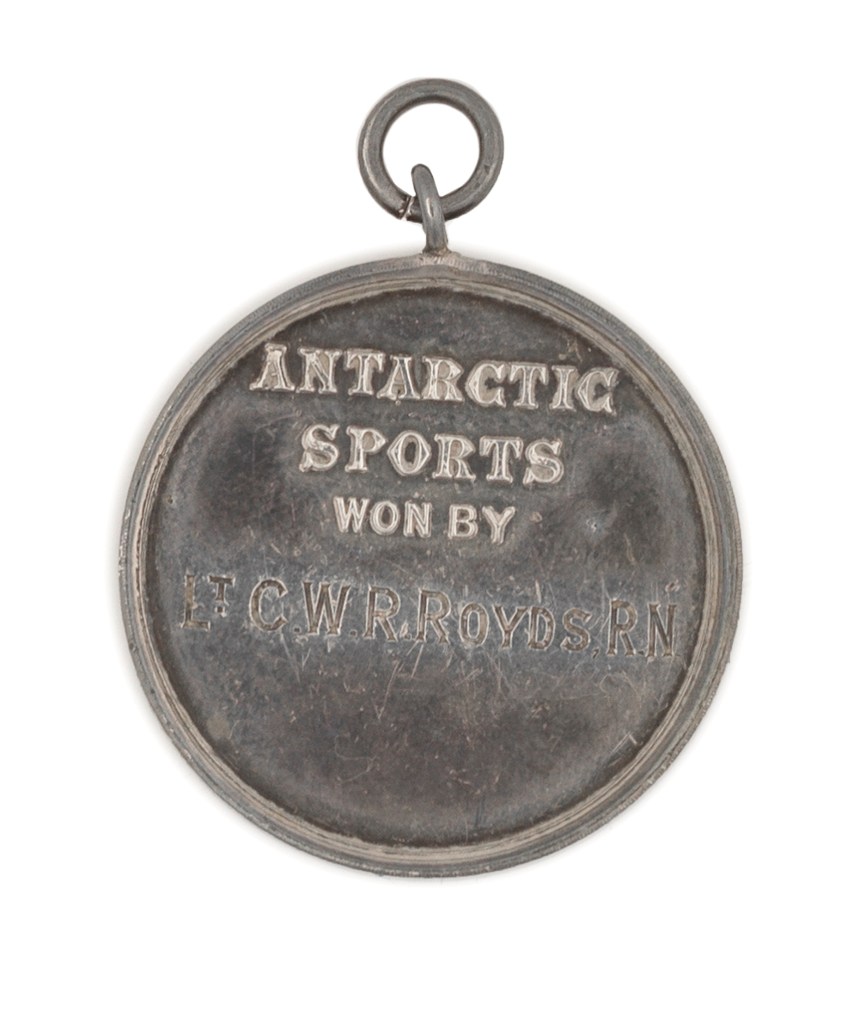 The reverse, or back, of the silver sporting medal given out during the 1901-1904 Discovery Expedition to the Antarctic. Apparently its recipient, Charles Royds, had his name engraved on the medal after he returned to Britain.