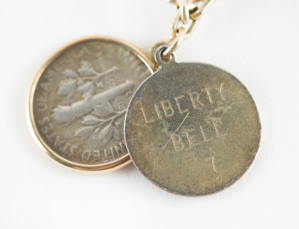 Among the charms on Jo Schirra's charm bracelet is a Liberty 7 dime that Gus Grissom brought on his Mercury mission.