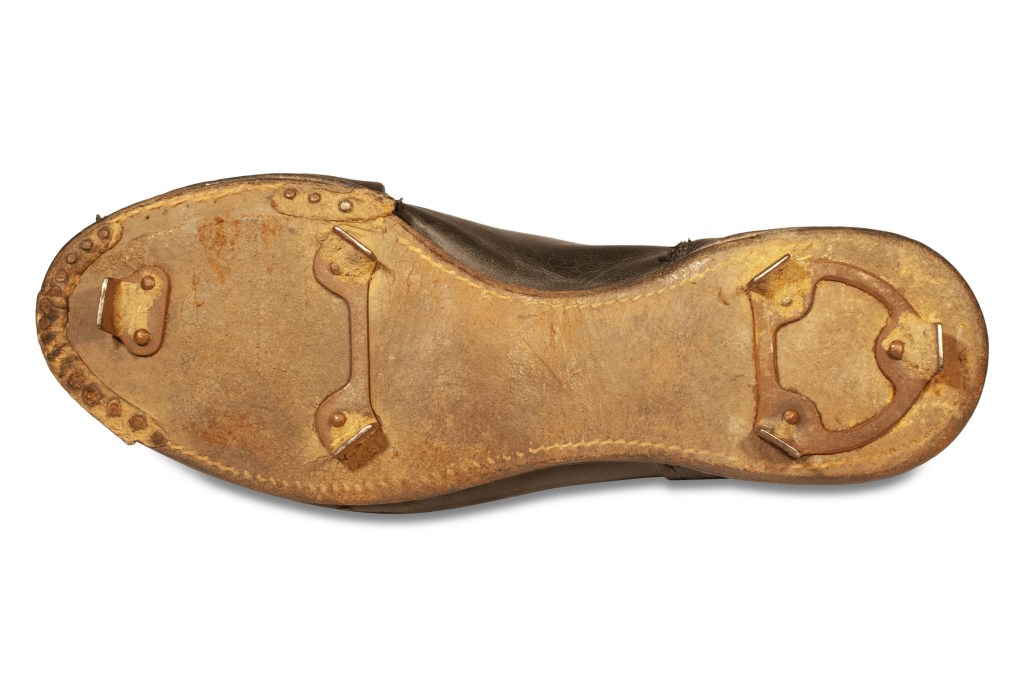 The Ted Williams cleats, tilted to show the spikes installed on their soles.