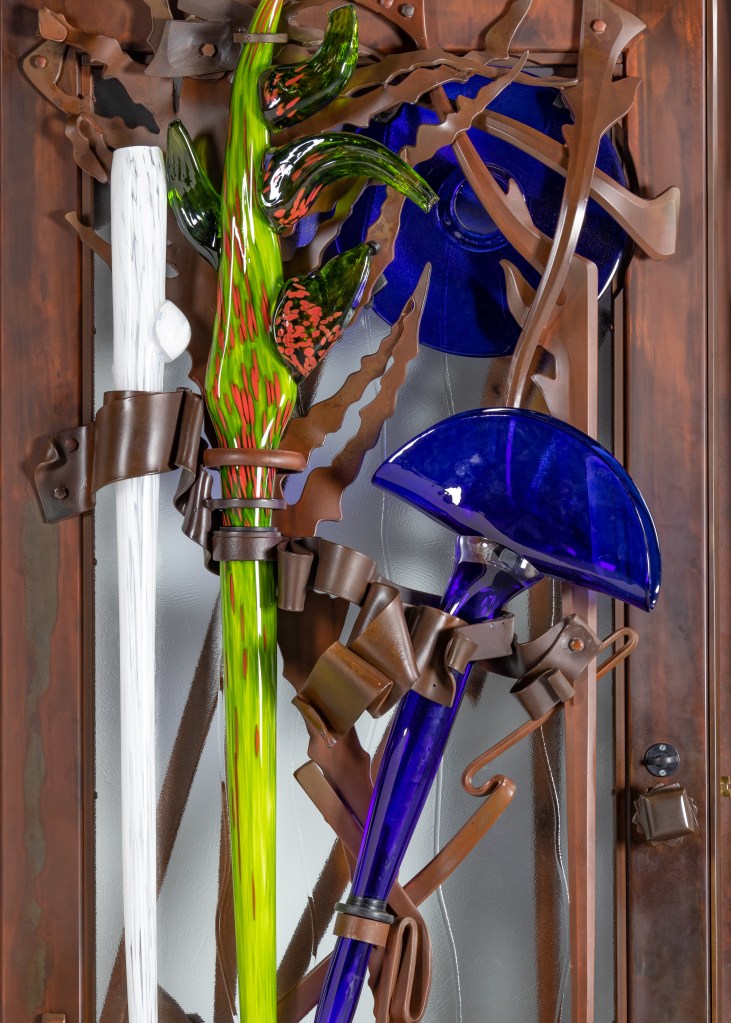 Detail of Albert Paley doors, showing colorful glass elements by Martin Blank.